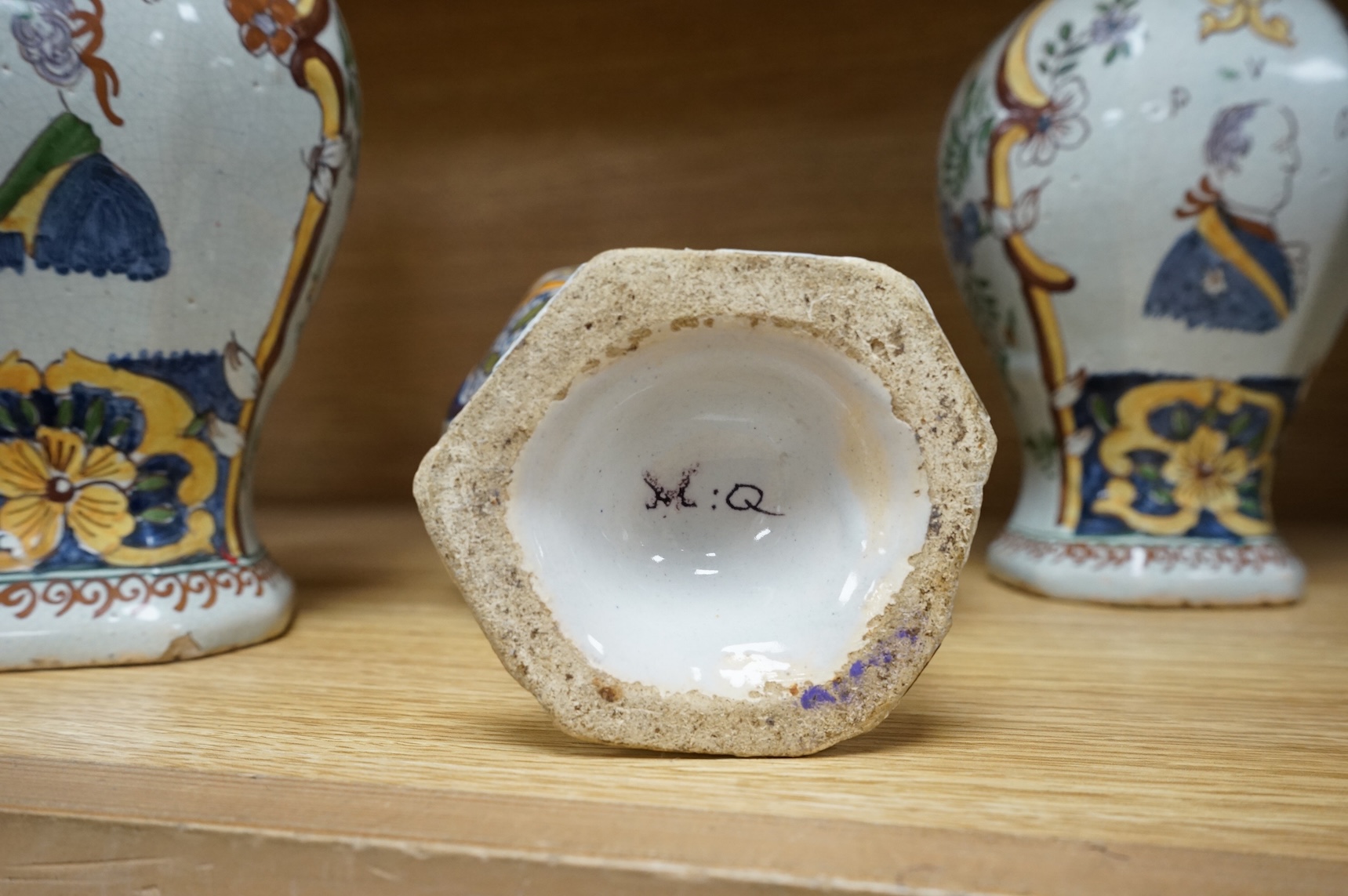 Three 18th/19th century Delft vases, the pair decorated with portraits of king and queen, H 30cm x W 15 (with lids), H 23cm x W 15 (without lid)